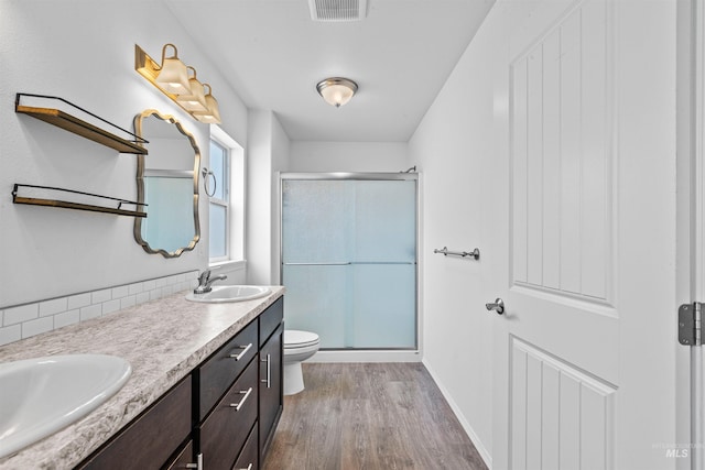 1724 Pioneer Dr, Lewiston, ID 83501 - full bathroom featuring wood finished floors, a shower stall, and double vanity