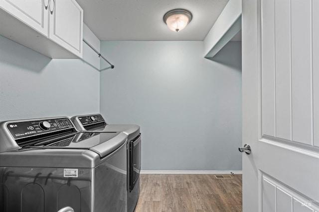 1724 Pioneer Dr, Lewiston, ID 83501 - laundry area with cabinet space, independent washer and dryer, and light wood-style floors