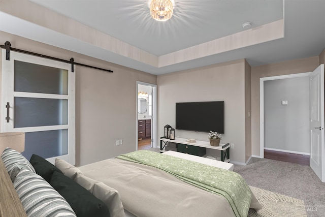 1724 Pioneer Dr, Lewiston, ID 83501 - bedroom with a barn door, carpet floors, ensuite bath, and a tray ceiling