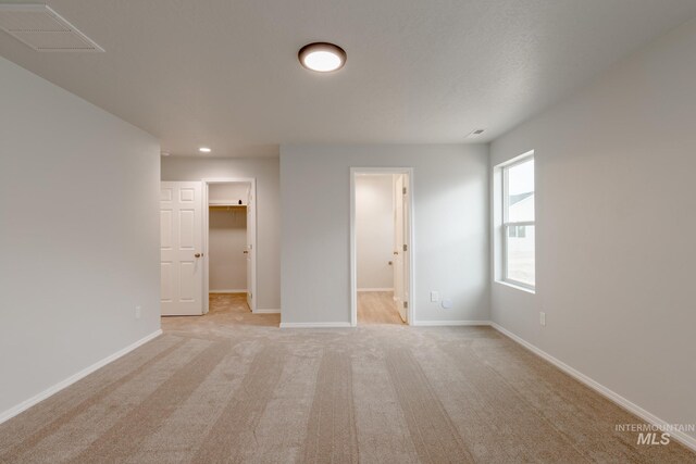 empty room featuring a textured ceiling and carpet floors