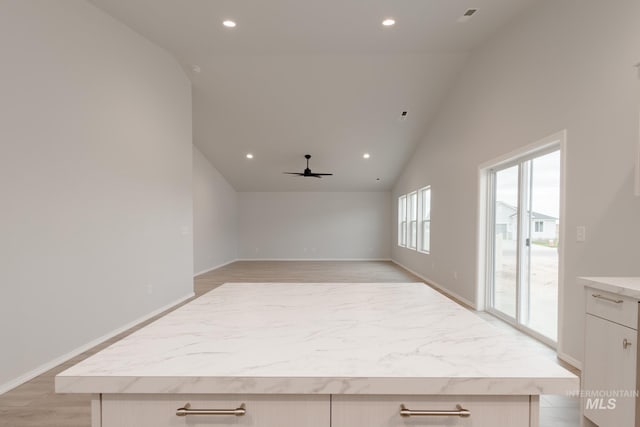 interior space featuring light hardwood / wood-style flooring, high vaulted ceiling, and ceiling fan