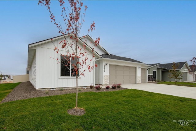 single story home with a garage and a front lawn