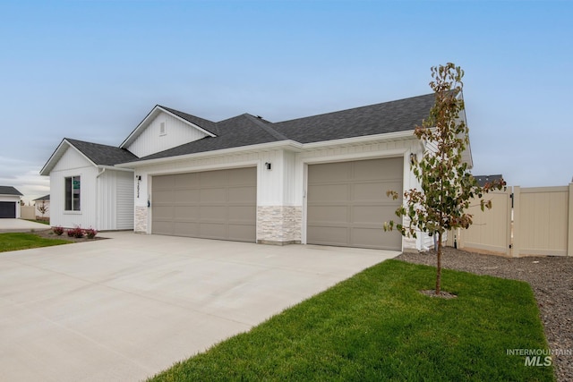 ranch-style home with a front yard and a garage