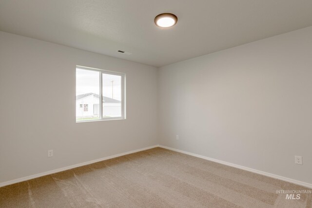 carpeted empty room featuring a textured ceiling