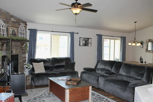 4951 W Torana St, Meridian, ID 83646 - living area featuring vaulted ceiling, wood finished floors, a chandelier, ceiling fan, and a stone fireplace