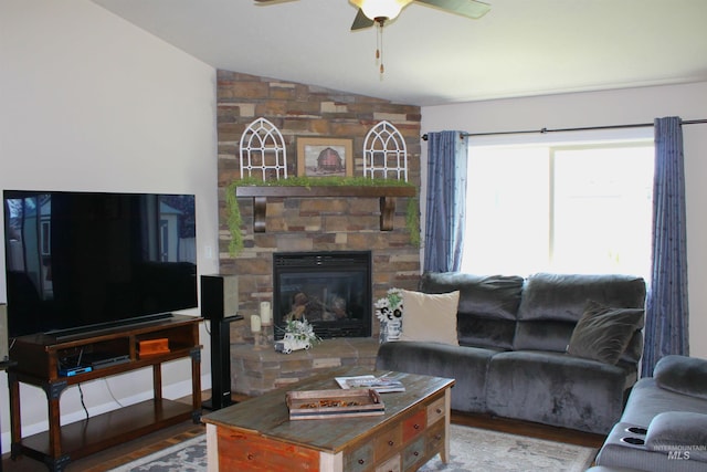 4951 W Torana St, Meridian, ID 83646 - living area with lofted ceiling, wood finished floors, ceiling fan, and a stone fireplace