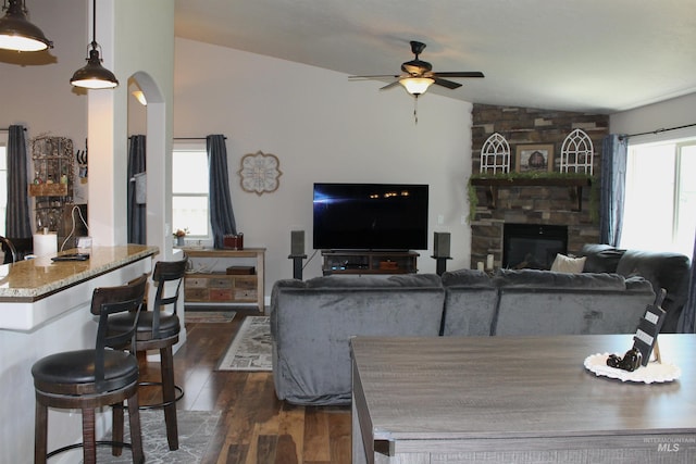 4951 W Torana St, Meridian, ID 83646 - living room featuring vaulted ceiling, ceiling fan, dark wood-style floors, and a fireplace