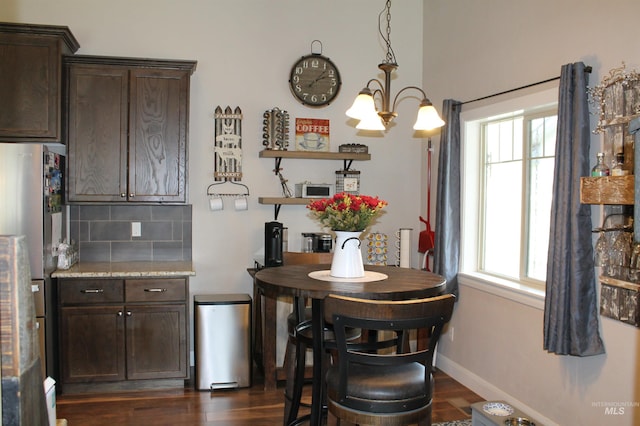 4951 W Torana St, Meridian, ID 83646 - dining space with dark wood-type flooring and baseboards