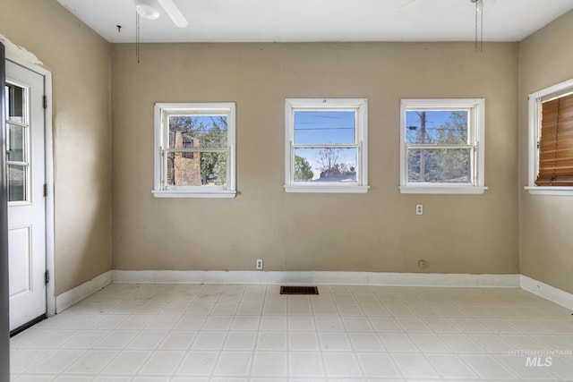 1631 Poplar Ave, Twin Falls, ID 83301 - unfurnished room with visible vents, baseboards, ceiling fan, and a wealth of natural light