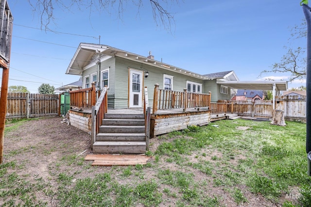 1631 Poplar Ave, Twin Falls, ID 83301 - rear view of house featuring a fenced backyard, a wooden deck, and a yard