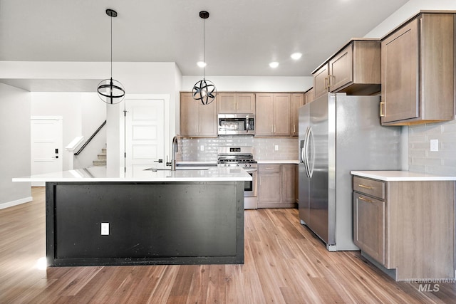 1755 N Crystal Cove Ave, Meridian, ID 83646 - kitchen with stainless steel appliances, light wood-style floors, decorative backsplash, light countertops, and recessed lighting