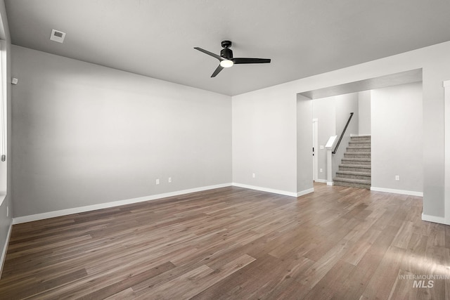 1755 N Crystal Cove Ave, Meridian, ID 83646 - unfurnished room with stairway, a ceiling fan, and wood finished floors