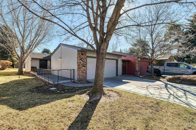 view of home's exterior featuring a yard, driveway, and an attached garage