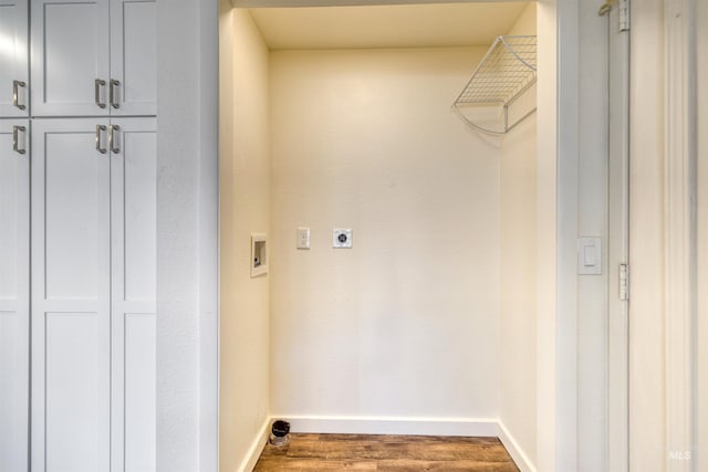 clothes washing area featuring hookup for a washing machine, cabinet space, electric dryer hookup, wood finished floors, and baseboards