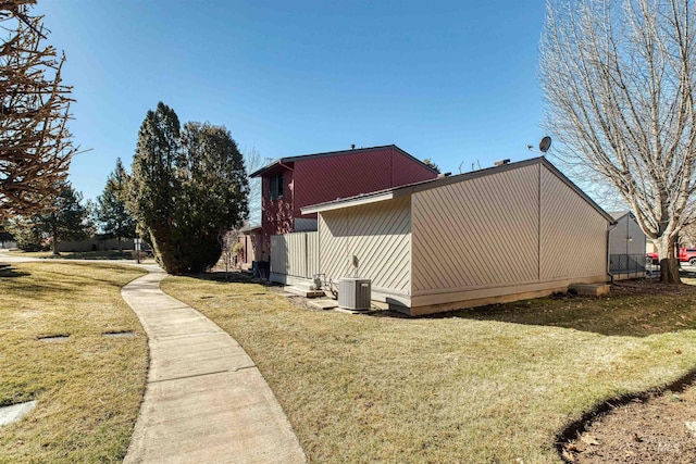 view of property exterior featuring a lawn and central air condition unit