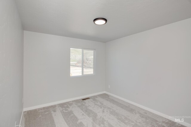 4391 N Magical Creek Ave, Meridian, ID 83646 - unfurnished room featuring visible vents, baseboards, and carpet floors