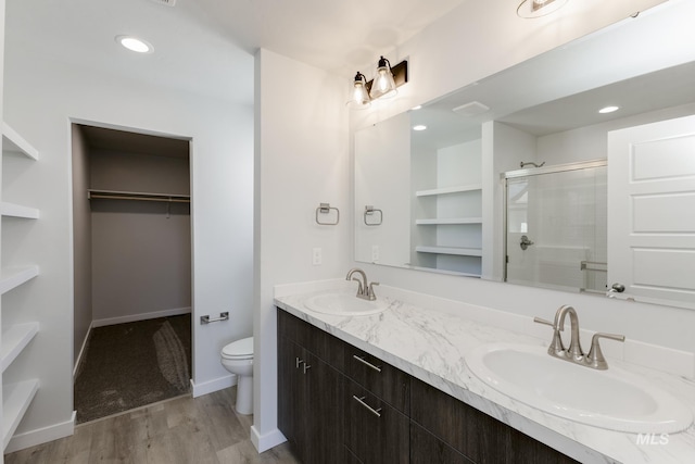 4391 N Magical Creek Ave, Meridian, ID 83646 - bathroom with a sink, toilet, a stall shower, and wood finished floors