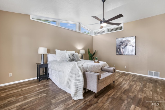 bedroom with dark wood-style floors, baseboards, vaulted ceiling, and a ceiling fan