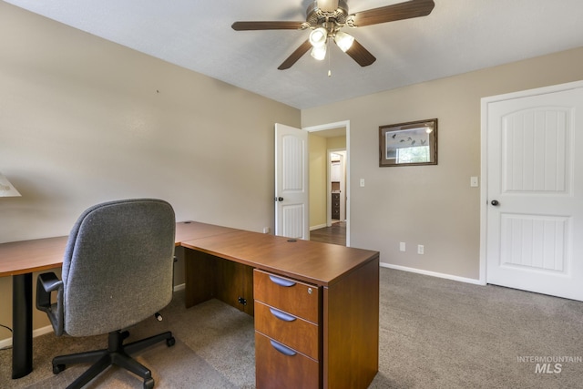 office space with carpet flooring, a ceiling fan, and baseboards