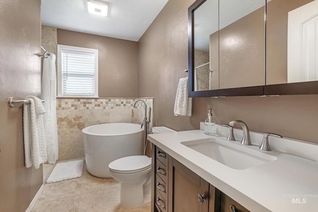 bathroom featuring a freestanding tub, vanity, tile patterned floors, a textured wall, and curtained shower
