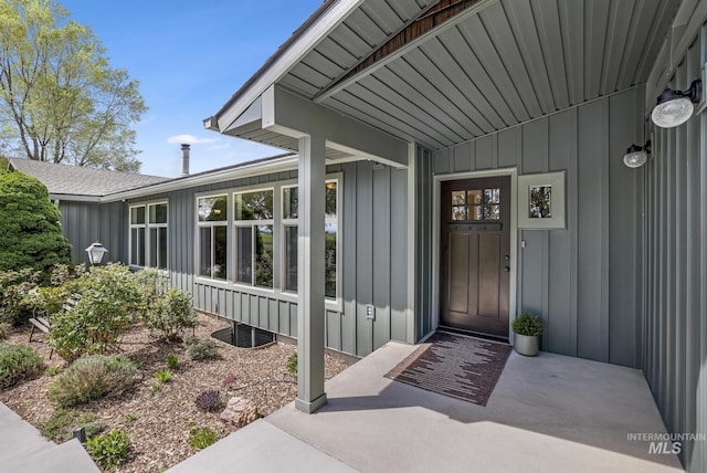 view of exterior entry with board and batten siding