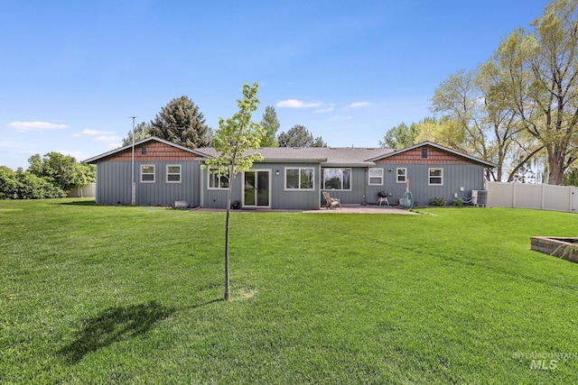 rear view of house featuring board and batten siding, cooling unit, and a patio