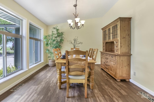 dining area with a chandelier, healthy amount of natural light, dark wood-style floors, and baseboards