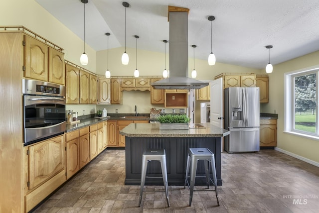 kitchen with stainless steel appliances, vaulted ceiling, stone finish floors, a kitchen island, and a breakfast bar