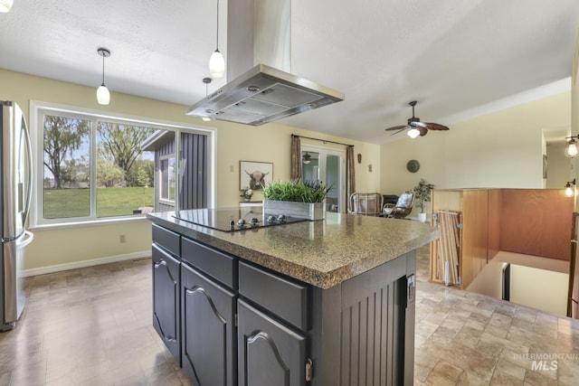 kitchen featuring island exhaust hood, stainless steel refrigerator with ice dispenser, black electric cooktop, dark countertops, and a kitchen island