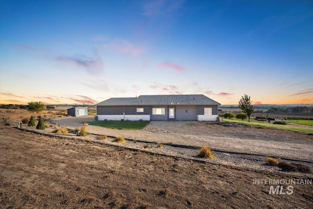 view of back house at dusk