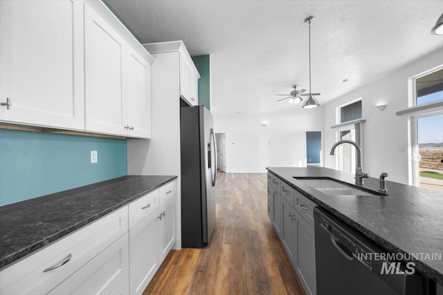 kitchen with dishwasher, white cabinetry, sink, and stainless steel fridge with ice dispenser