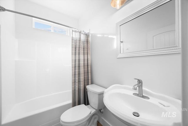 full bathroom with toilet, shower / bathtub combination with curtain, and sink