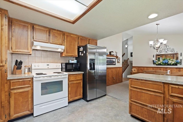 11722 W Jenilyn, Boise, ID 83713 - kitchen featuring white electric range, stainless steel fridge, under cabinet range hood, black microwave, and a wainscoted wall
