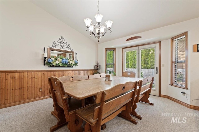 11722 W Jenilyn, Boise, ID 83713 - dining space with a chandelier, light carpet, lofted ceiling, a wainscoted wall, and wood walls