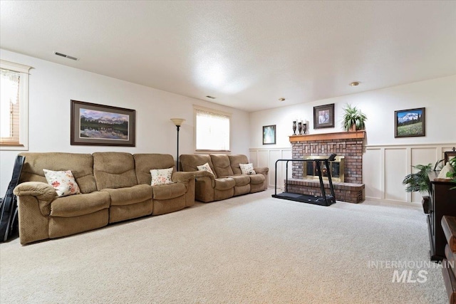 11722 W Jenilyn, Boise, ID 83713 - living room with carpet, a fireplace, and a wainscoted wall
