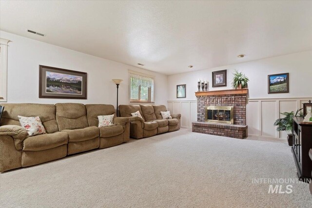 11722 W Jenilyn, Boise, ID 83713 - carpeted living area with wainscoting, a brick fireplace, and a decorative wall