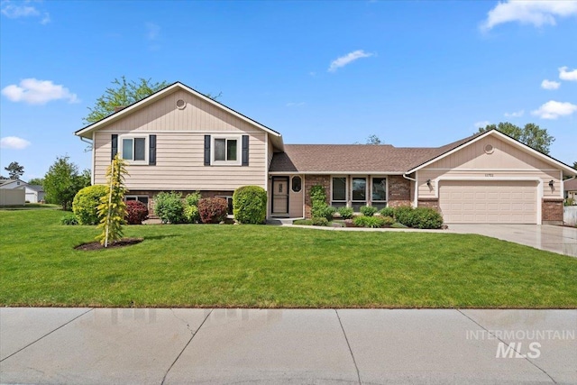 11722 W Jenilyn, Boise, ID 83713 - tri-level home featuring an attached garage, driveway, a front yard, and brick siding