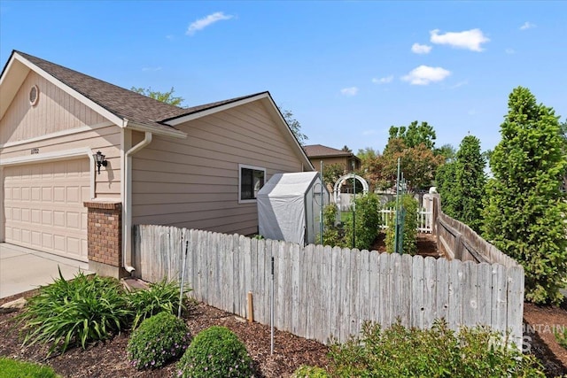 11722 W Jenilyn, Boise, ID 83713 - view of home's exterior with fence, an attached garage, a shingled roof, and concrete driveway
