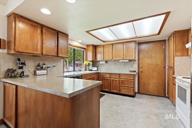 11722 W Jenilyn, Boise, ID 83713 - kitchen with white electric stove, brown cabinets, tasteful backsplash, a peninsula, and light countertops