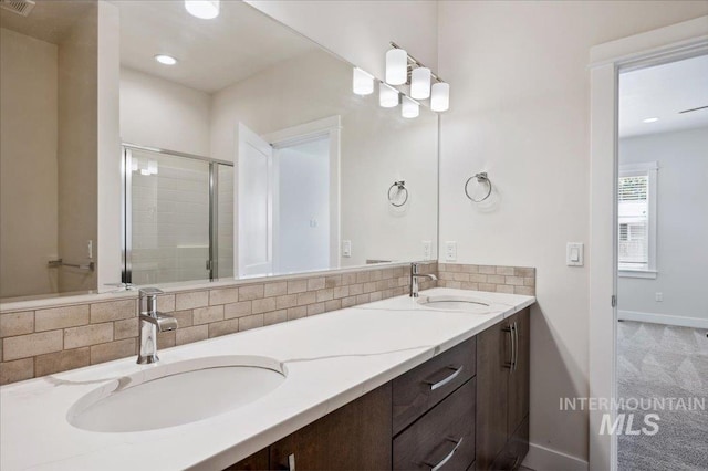 10276 W Utahna Rd, Boise, ID 83714 - full bath featuring double vanity, decorative backsplash, a shower stall, and baseboards