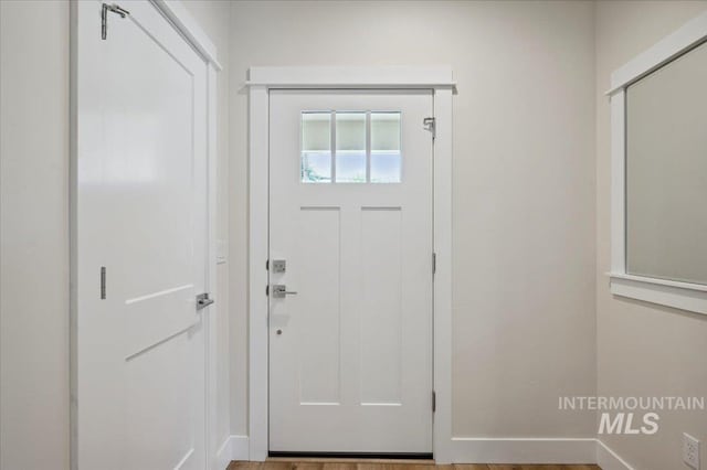 10276 W Utahna Rd, Boise, ID 83714 - doorway to outside featuring baseboards