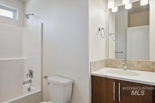 10276 W Utahna Rd, Boise, ID 83714 - full bathroom with vanity, toilet, tub / shower combination, and decorative backsplash