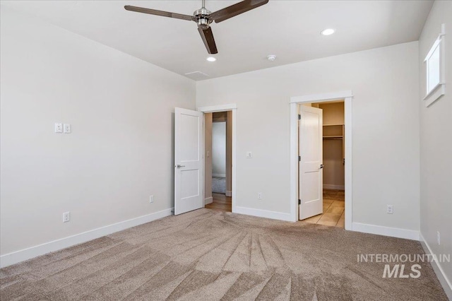 10276 W Utahna Rd, Boise, ID 83714 - unfurnished bedroom featuring light carpet, baseboards, recessed lighting, a walk in closet, and a ceiling fan
