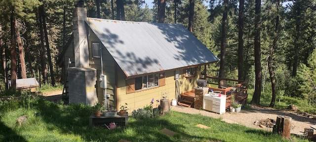 11 Turner Cir, Boise, ID 83716 - view of side of property with a metal roof, a chimney, and a wooden deck