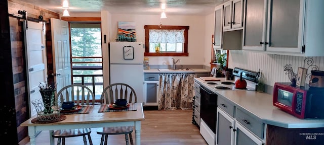 11 Turner Cir, Boise, ID 83716 - kitchen featuring white appliances, light countertops, plenty of natural light, and light wood-type flooring