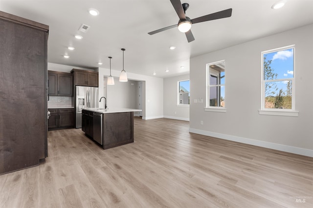 202 S Koyukuk Ln, Star, ID 83669 - kitchen featuring stainless steel appliances, light countertops, baseboards, recessed lighting, and open floor plan