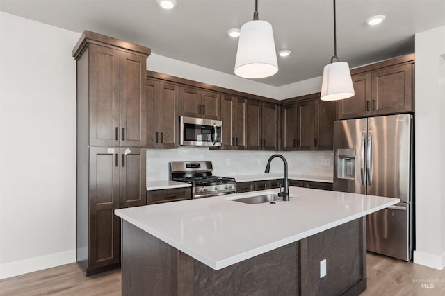 202 S Koyukuk Ln, Star, ID 83669 - kitchen with stainless steel appliances, a sink, light wood-type flooring, baseboards, and recessed lighting