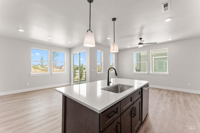 202 S Koyukuk Ln, Star, ID 83669 - kitchen with a sink, open floor plan, light wood-style floors, dishwasher, and dark brown cabinets