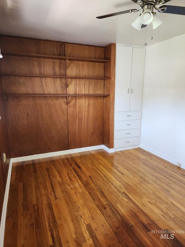855 N 9th E, Mountain Home, ID 83647 - unfurnished bedroom with wood finished floors, baseboards, and a ceiling fan