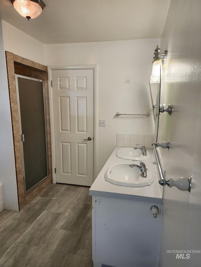 855 N 9th E, Mountain Home, ID 83647 - bathroom with a shower stall, double vanity, and wood finished floors